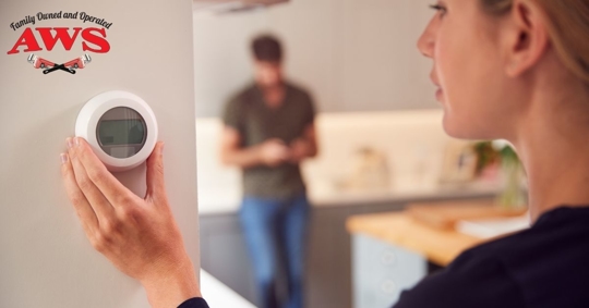 Woman changing thermostat